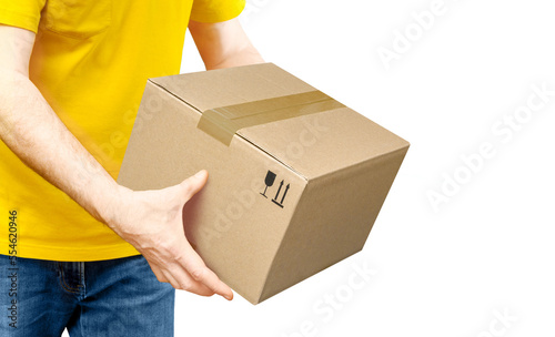 Delivery man in yellow shirt is giving parcel isolated on white.