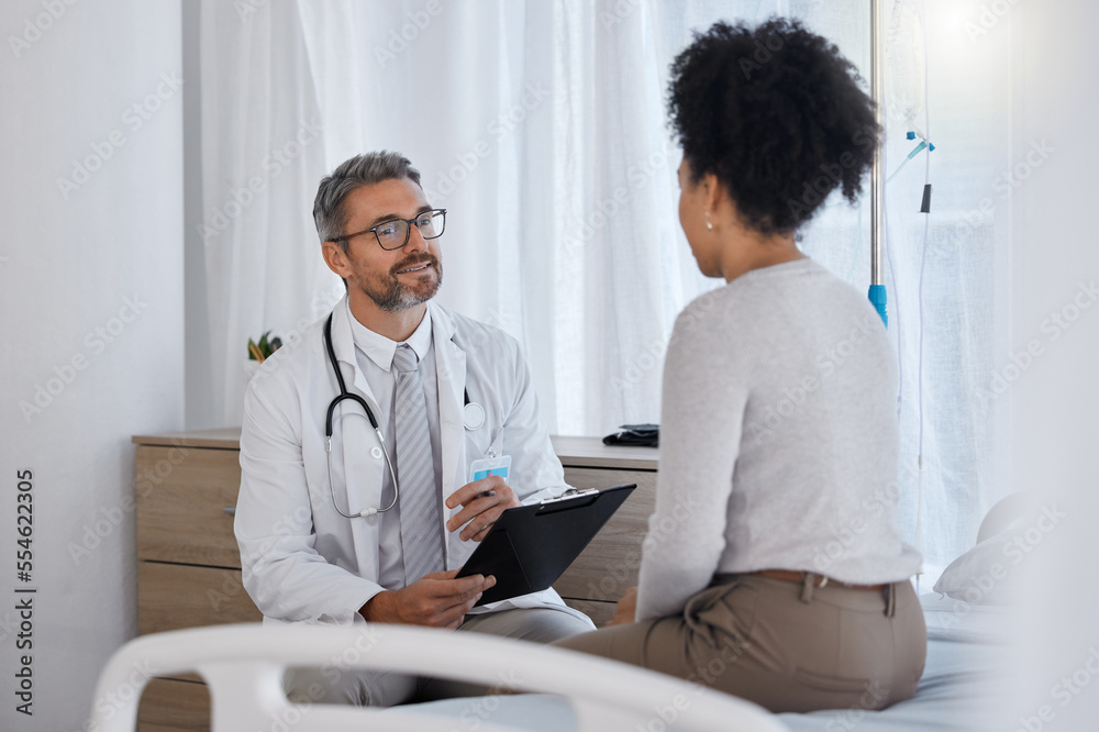 Obraz premium Doctor, patient and hospital consultation while talking about healthcare, health insurance and results with checklist for examination and therapy. Man and woman together for wellness and counseling