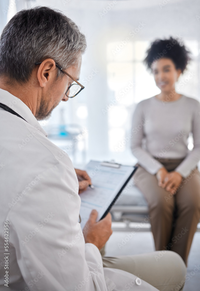 Doctor, consultation and writing on clipboard with patient in hospital office for symptoms, records or notes. Healthcare, wellness or black woman consulting medical physician with checklist in clinic Doctor, consultation and writing on clipboard with patient in hospital office for symptoms, records or notes. Healthcare, wellness or black woman consulting medical physician with checklist in clinic