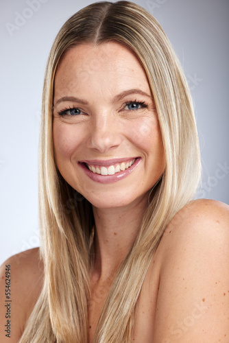 Portrait  beauty and skincare with a model woman in studio on a gray background for natural treatment. Face  happy and smile with an attractive young female posing to promote a cosmetic product
