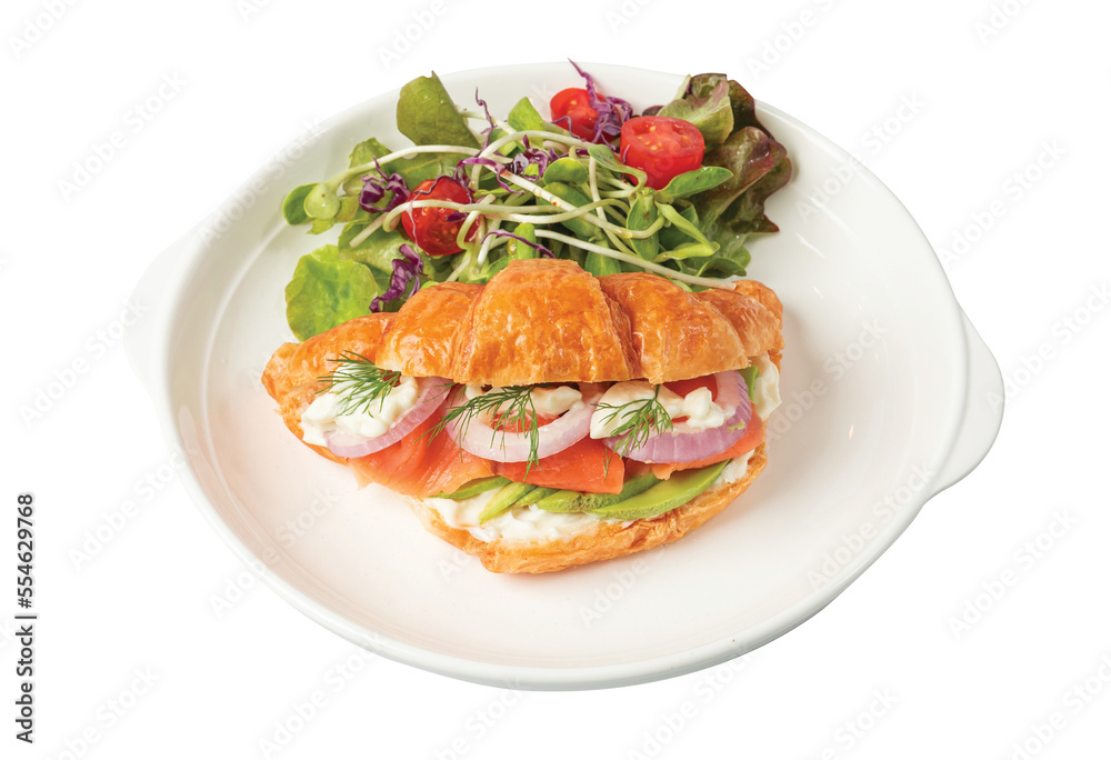 Png Croissant sandwich with salmon on white plate, served with fresh salad leaves. 
