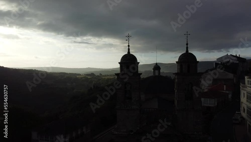 Orbital view of a drone over the church of Castro Caldelas, Galicia-Spain. Beautiful village of the Ribiera Sacra in the province of Ourense. In the movement of the camera we can see the village with  photo