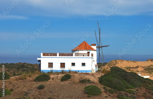 Beautiful Carrapateira windmill at the west Algarve coast of Portugal at praia da Bordeira photo