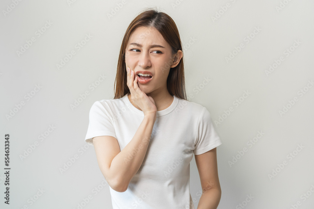 Face expression suffering from sensitive teeth and cold, asian young woman, girl feeling hurt, pain touching cheek, mouth with hand. Toothache molar tooth, dental problem isolated on white background. Face expression suffering from sensitive teeth and cold, asian young woman, girl feeling hurt, pain touching cheek, mouth with hand. Toothache molar tooth, dental problem isolated on white background.