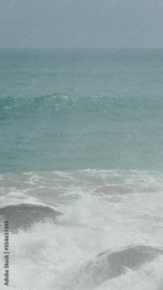 big waves crashing on stone beach. Vertical video big waves crashing on stone beach. Vertical video