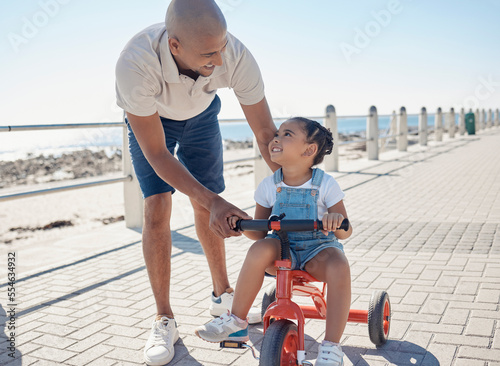 Canvas Print Father, girl child and tricycle at park, learning and happy in ocean sunshine on family vacation