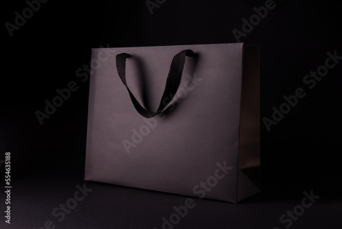 Black Friday Shopping Bag Mockup. Minimalists Black Paper Shopping Bag on a Black Background.