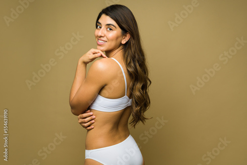 Athletic fit woman in her underwear smiling making eye contact