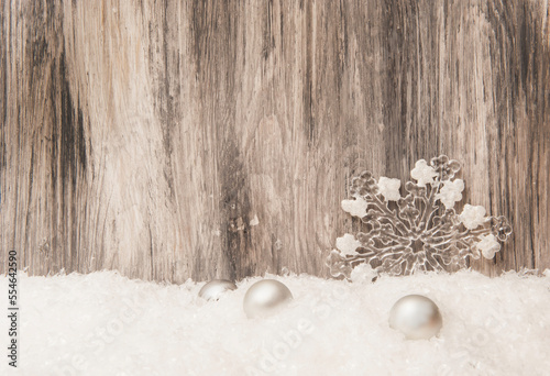 Christmas Wooden gray background with Christmas tree decorations and artificial snow photo