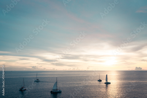 Golden sunset shine over the sea with sailboats © TeeRaiden