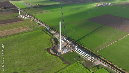 Construction site of a wind turbine windmill. Green energy generation in The Netherlands. Sustainable energy transistion in the making. Aerial drone view. Build using cranes. Green electric energy. photo