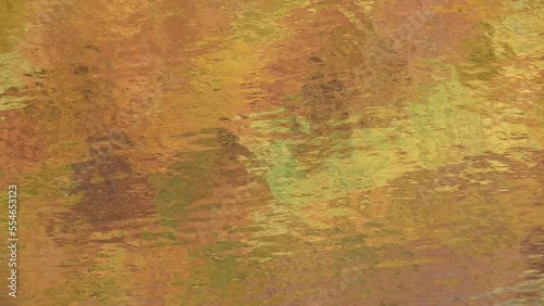 Autumn forest with a reflection on the restless surface of the lake 