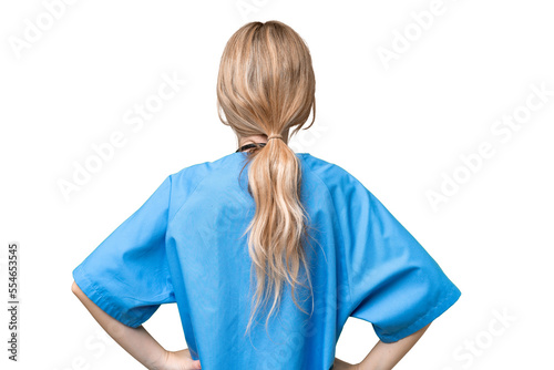 Young nurse English woman over isolated background in back position