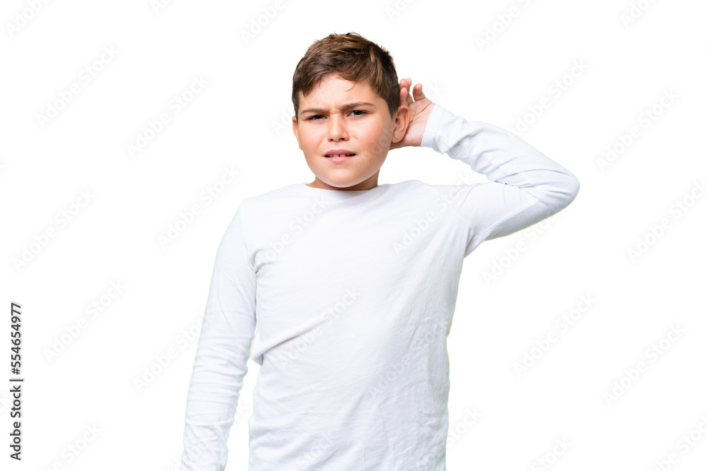 Little caucasian kid over isolated chroma key background listening to something by putting hand on the ear Little caucasian kid over isolated chroma key background listening to something by putting hand on the ear