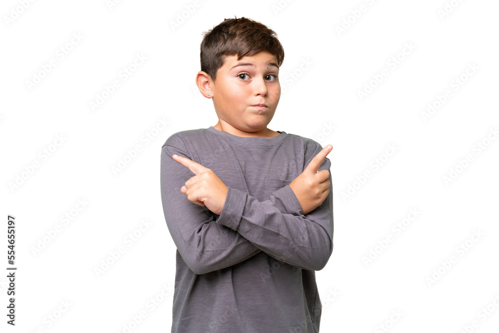 Little caucasian kid over isolated chroma key background pointing to the laterals having doubts Little caucasian kid over isolated chroma key background pointing to the laterals having doubts