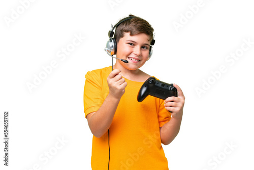 Little caucasian kid playing with a video game controller over isolated chroma key background making money gesture