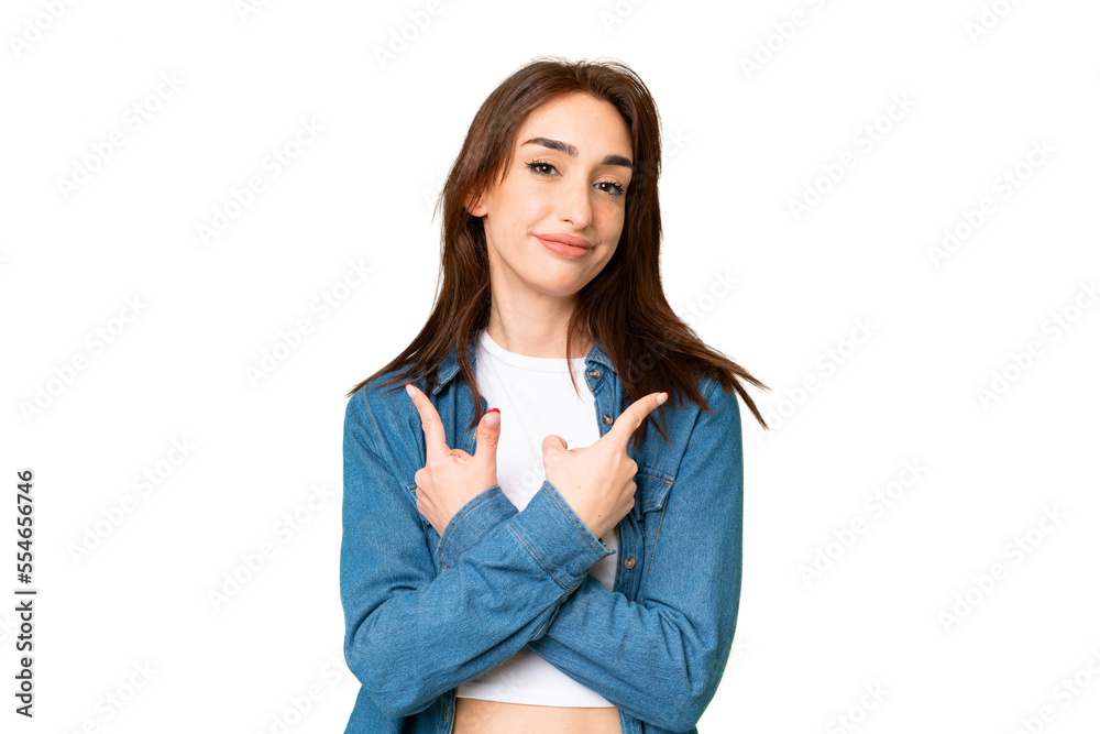 Young caucasian woman over isolated chroma key background pointing to the laterals having doubts Young caucasian woman over isolated chroma key background pointing to the laterals having doubts