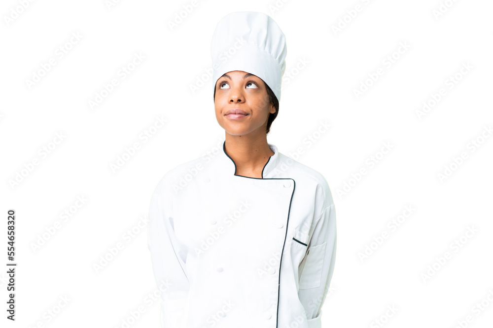 Young African American chef over isolated chroma key background and looking up Young African American chef over isolated chroma key background and looking up