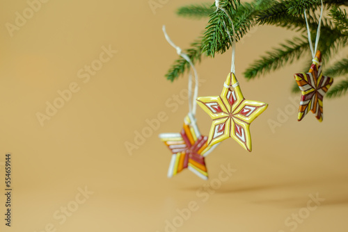 Ceramic Christmas stars on fir branches © Syoma Barva