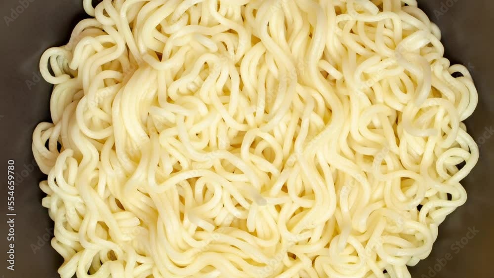 Noodles instant, cooked, close-up, rotating, turning, macro, top view
