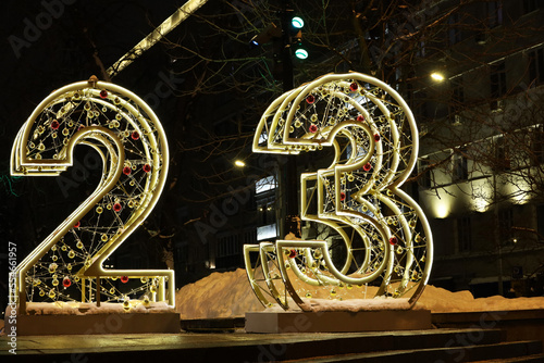New Year decorations on a night city street with big numbers 2023. Festive illumination, Christmas celebration