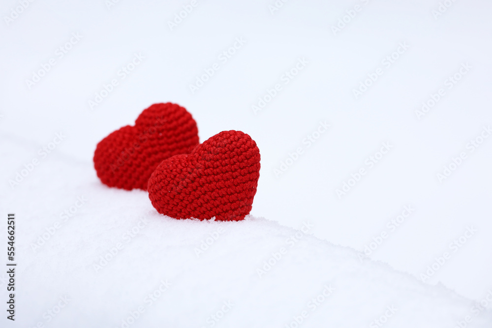 Fototapeta premium Two love hearts in snow, Valentine's card. Background for romantic event, Christmas celebration or winter weather