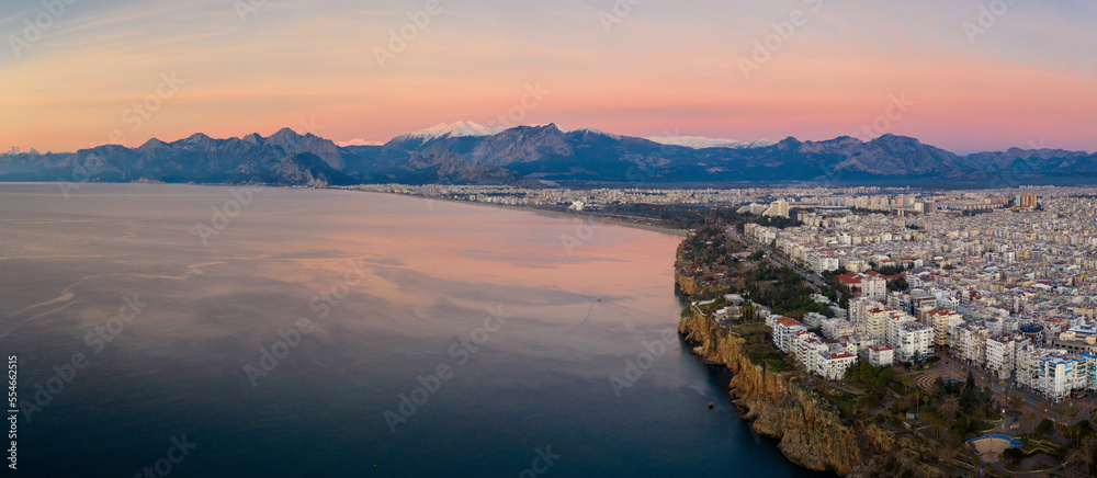 Panoramic aerial view of Antalya and covered with snow mountains at sunrise, Turkey.