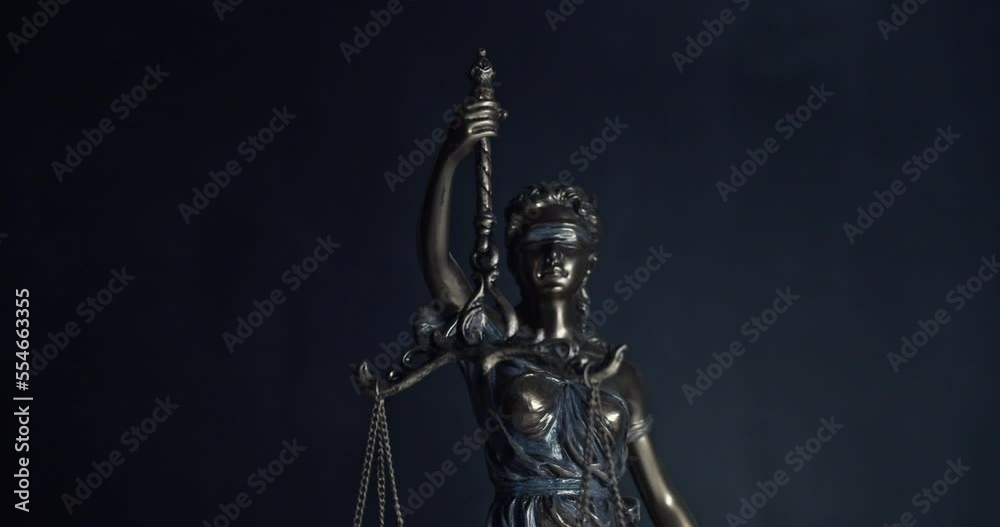 Legal law, patent attorney or successful lawyer concept. Bronze statue of themis or lady of justice on black background. Legal law, patent attorney or successful lawyer concept. Bronze statue of themis or lady of justice on black background.