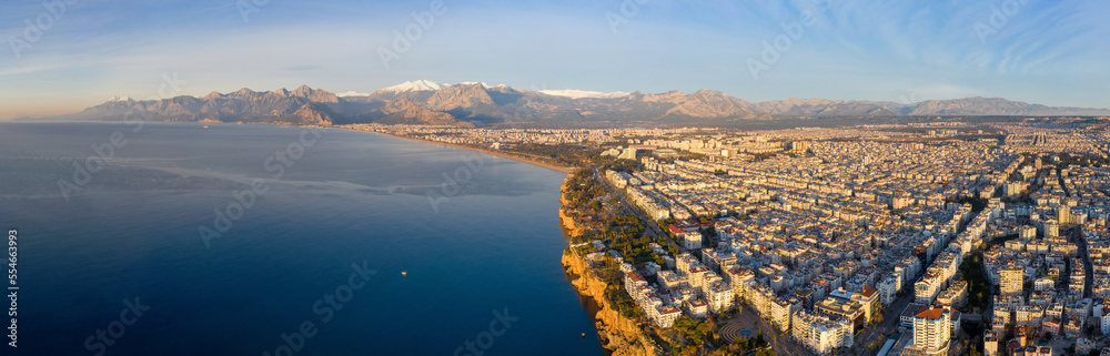 Panoramic drone view of Antalya and covered with snow mountains at sunrise. Turkey.