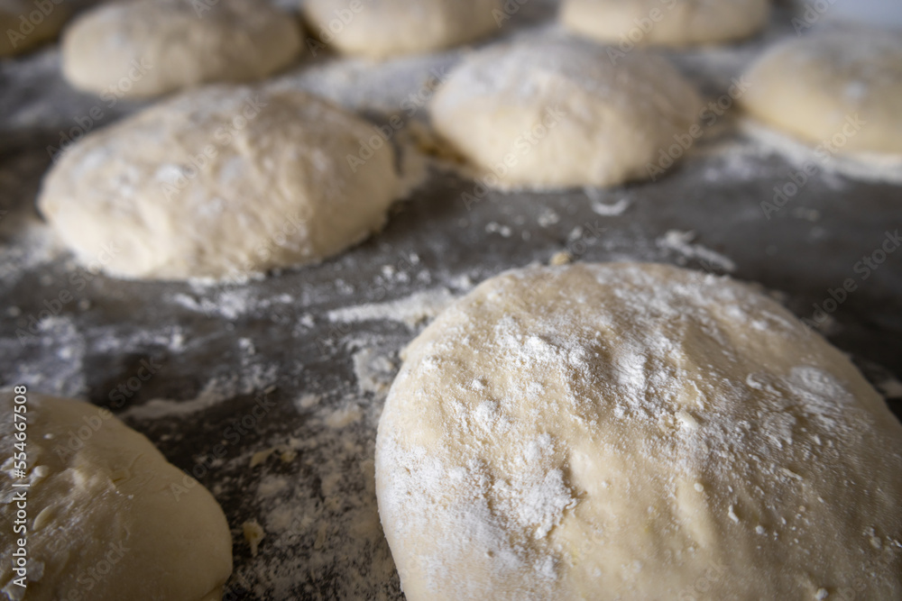 Dough for pizza in the process of leavening. Selective focus. Dough for pizza in the process of leavening. Selective focus.