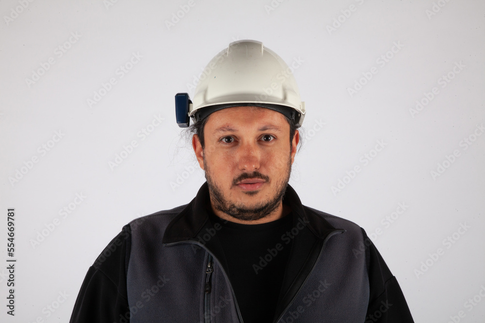 Portrait of a man with hard cap on white isolated background. Portrait of a man with hard cap on white isolated background.
