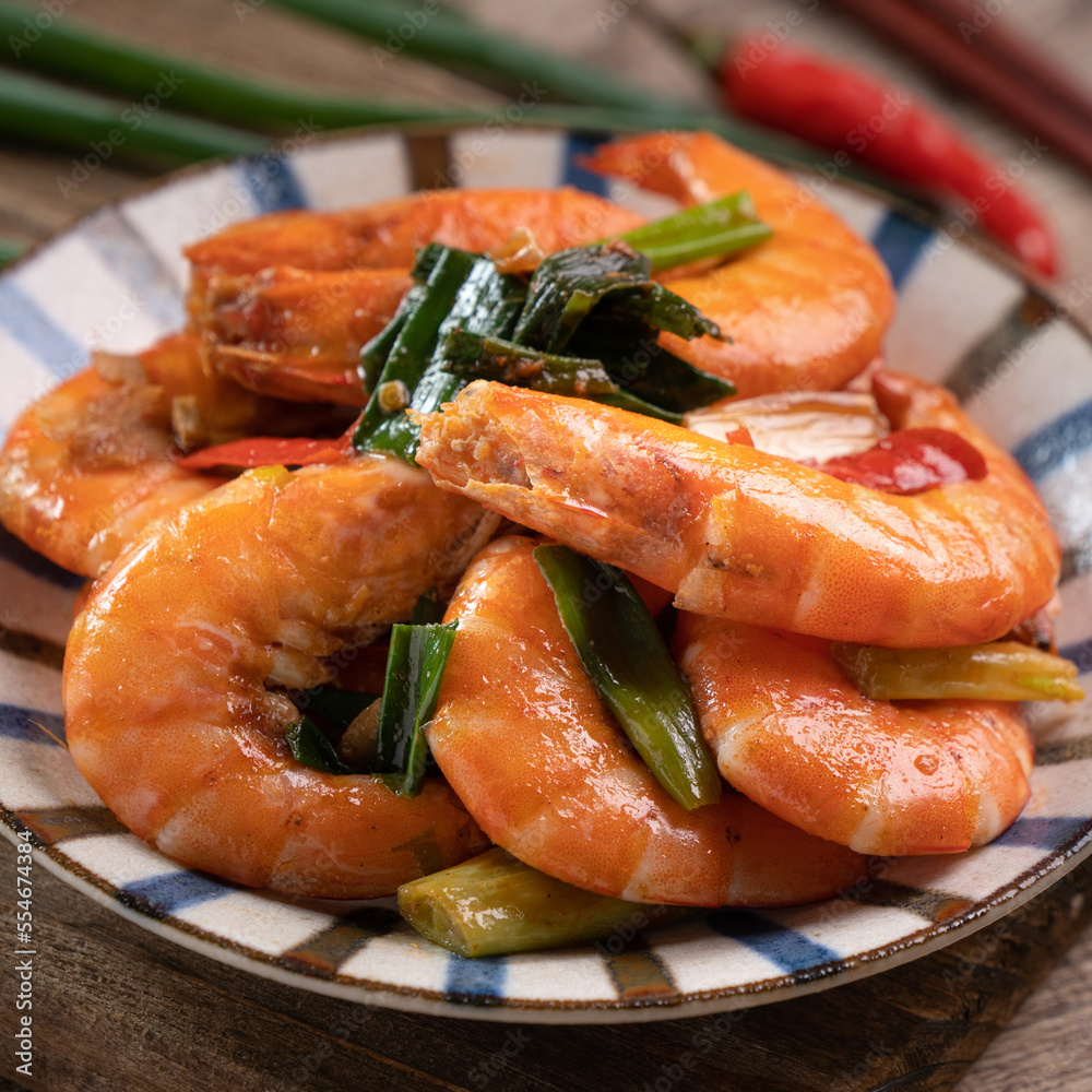 Delicious pan-fried shrimp on dark wooden table background. Delicious pan-fried shrimp on dark wooden table background.