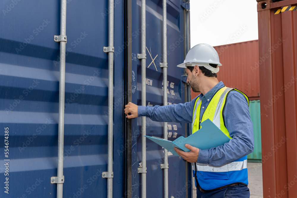 male engineers in a container shipping company Consulting to check the order for the container that is responsible