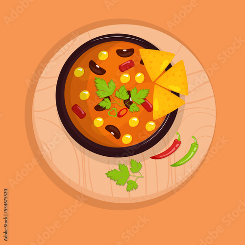 Mexican cuisine traditional dish chili con carne with nachos chips on the wooden cutting board. Top view.