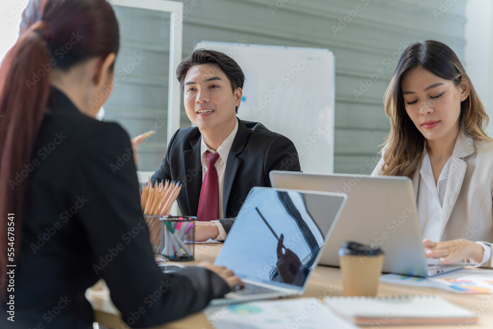 A group of young Asian businessmen Talking and planning work happily and have fun. at the company's office A group of young Asian businessmen Talking and planning work happily and have fun. at the company's office