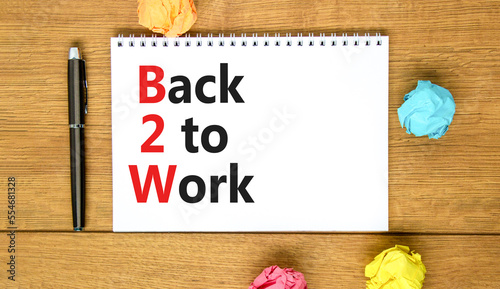 B2W back to work symbol. Concept words B2W back to work on white white note on a beautiful wooden background. Business and B2W back to work concept. Copy space.