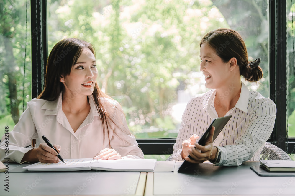 Marketer or analytic manager team dressed in suits working with paper charts and laptops at the meeting room.