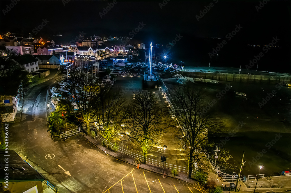 A view over Saundersfoot village and harbour at night time in Wales in winter