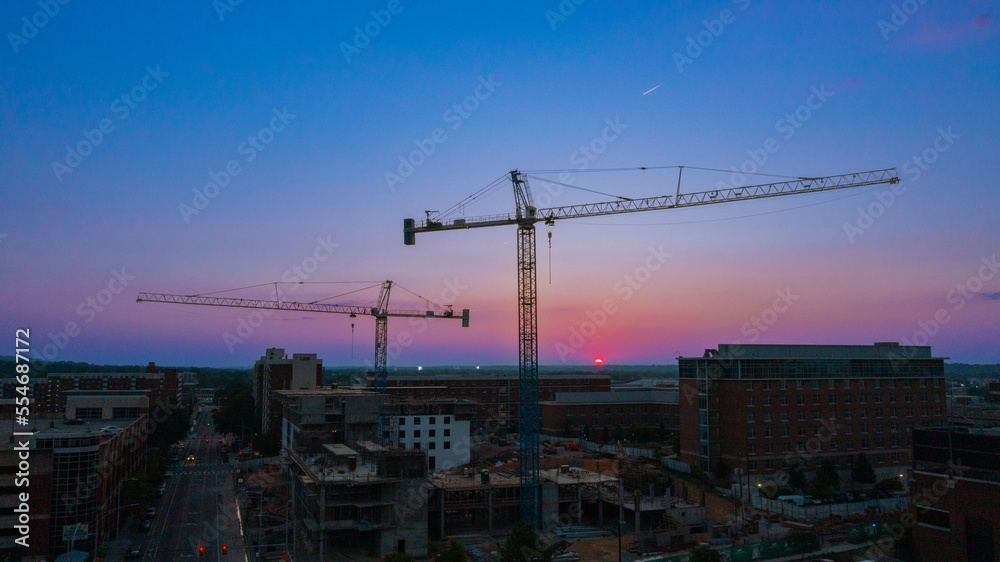 crane silhouette construction area on college campus 