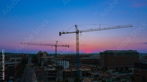 crane silhouette construction area on college campus  photo