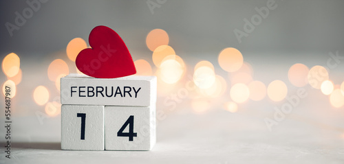 Small red heart on wooden calendar blocks. Valentine's day background