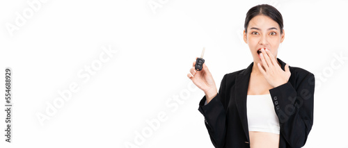 Young asian surprised and excited happy woman driver showing car key isolated on white background and copy space studio portrait Excite business female looking at camera use hands cover her mouth