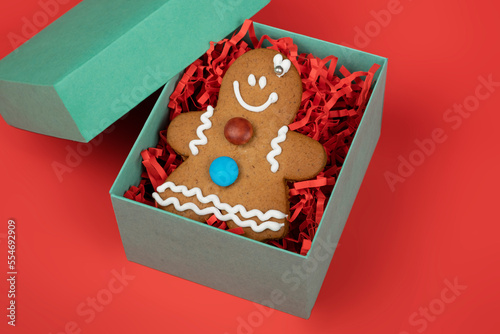 Cookie, Christmas man cookie on green gift box red background, isolated