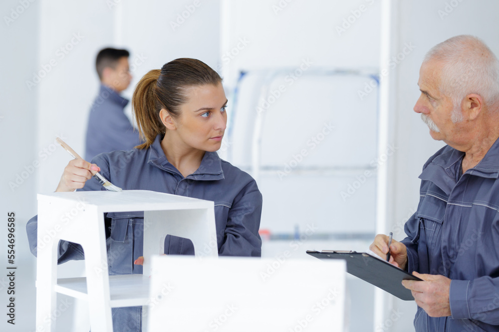 Fototapeta premium portrait of woman painting renewing chair