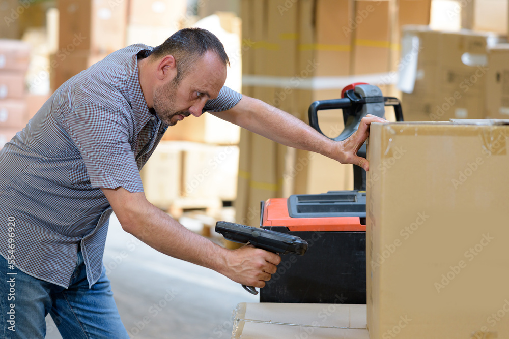 worker using handheld scan to box