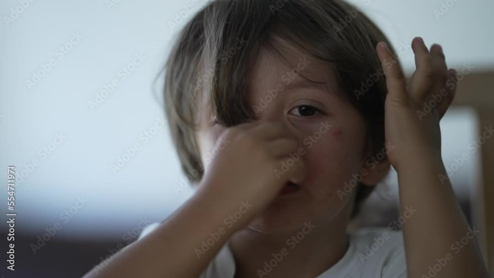 One tearful small boy close up face. Sad Child with tired pensive thoughtful expression One tearful small boy close up face. Sad Child with tired pensive thoughtful expression