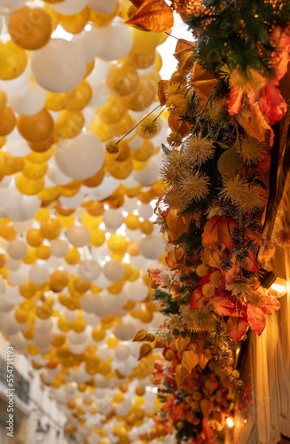 Paris, France - 12 18 2022: View of the Montorgueil street with gold and white cover balloons for Christmas photo