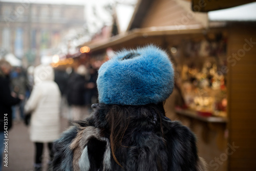 Closeup of young woman wearing a traditional russian hat in the street photo