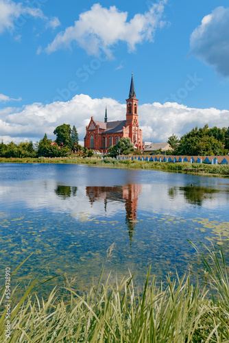 Roman Catholic Church of St. Anthony and its reflection in the lake in Postavy, Belarus.