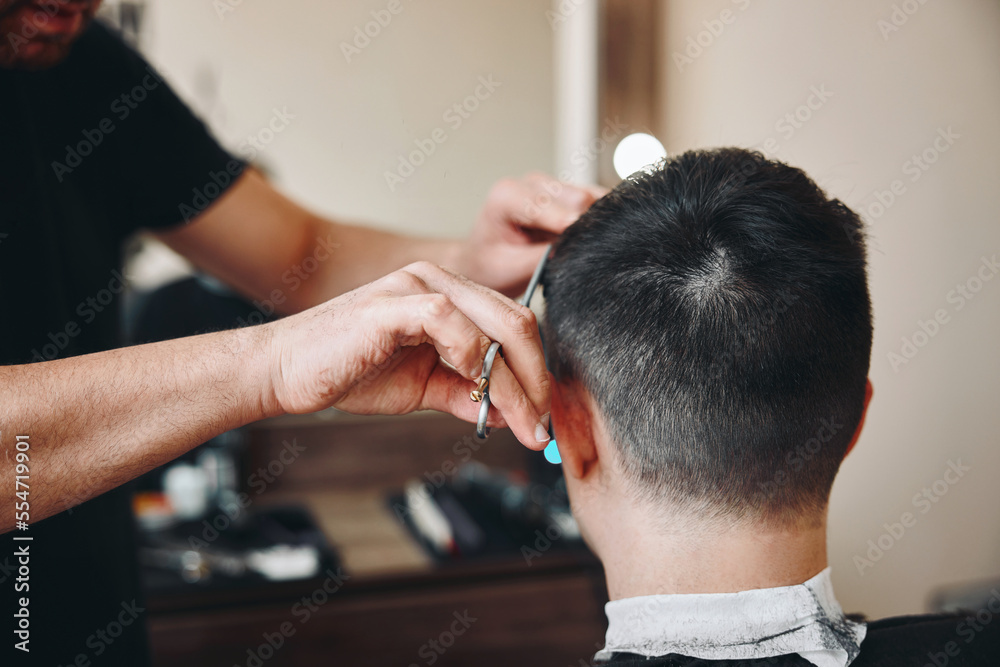 Fototapeta premium hairdresser does hairstyle and style with scissors